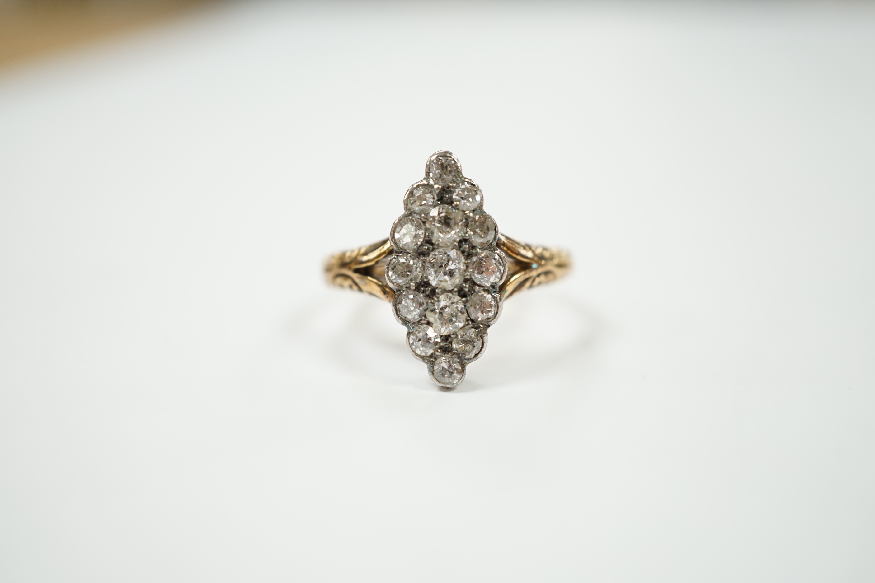 An 18ct and diamond set marquise cluster shaped ring, size N/O, gross weight 4 grams.